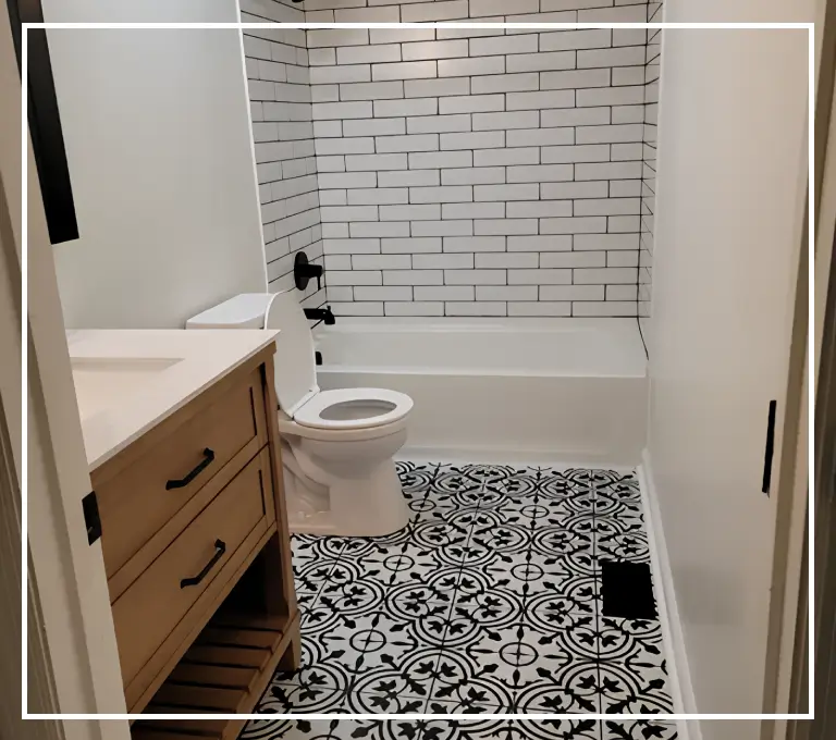 A bathroom with black and white tile floor