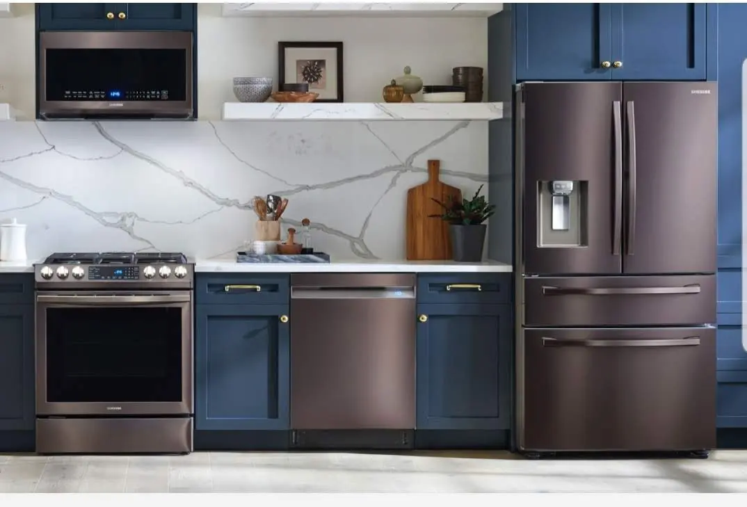 A kitchen with blue cabinets and brown appliances.